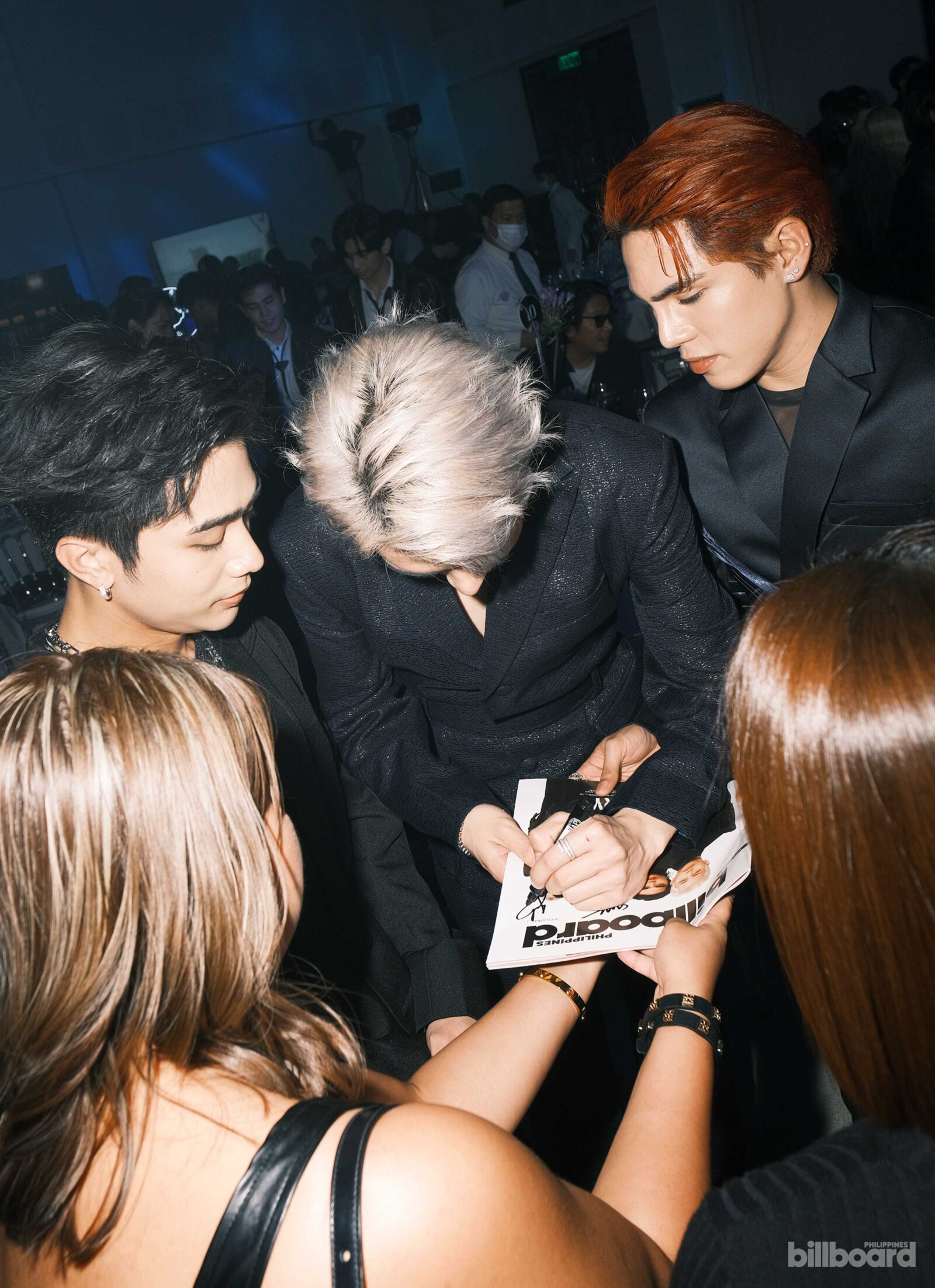SB19 signing a Billboard Philippines magazine
