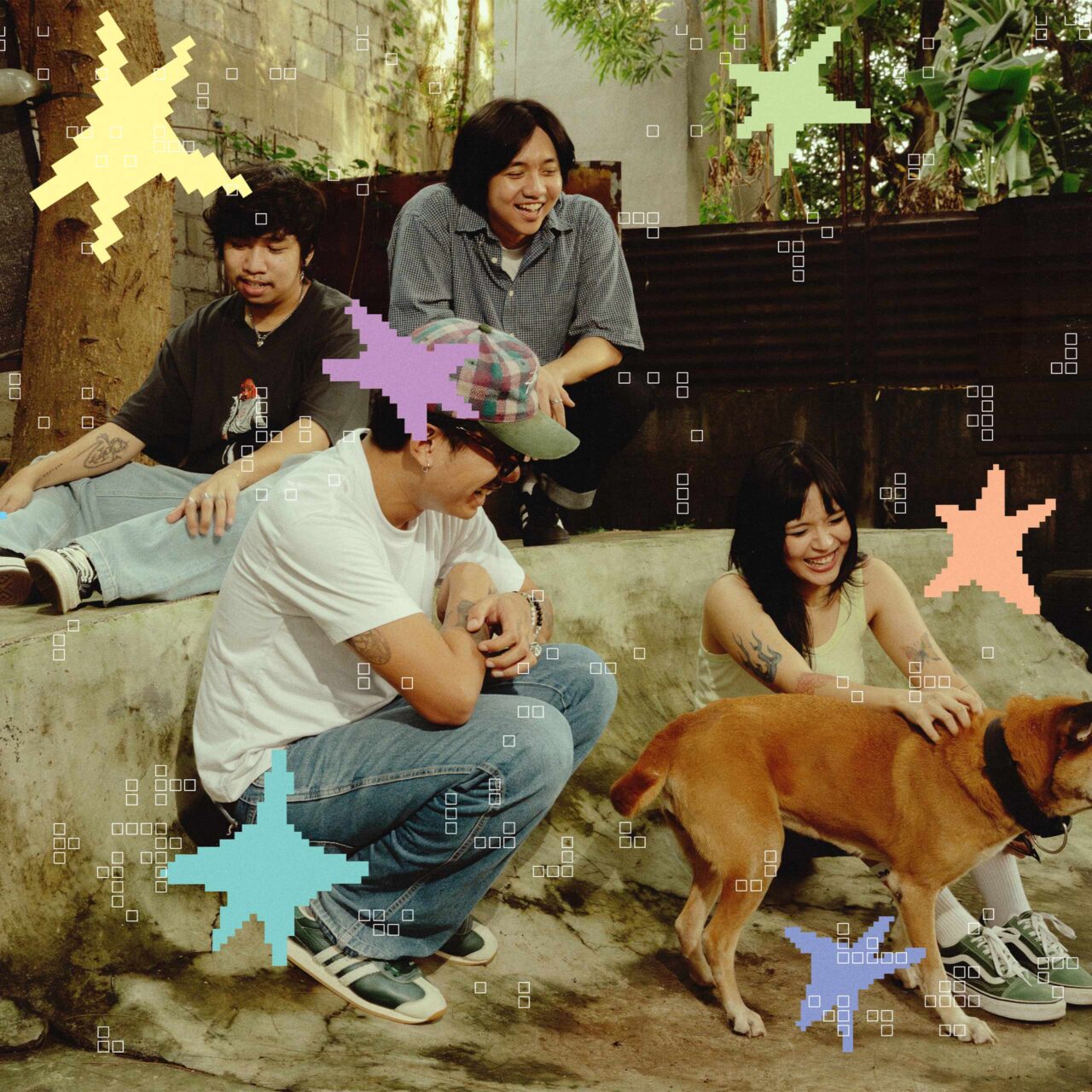 Four friends relaxing outdoors near a concrete ledge with a brown dog, sharing smiles in a casual, sunny setting.