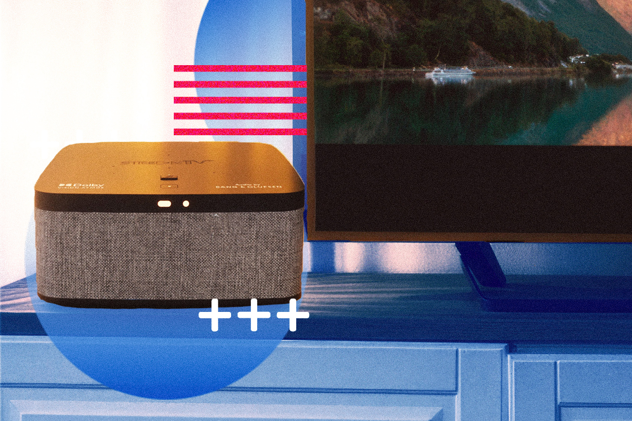 Smart speaker on a blue desk next to a flat-screen TV, with a blue circle and pink stripes overlay suggesting interaction or volume control.