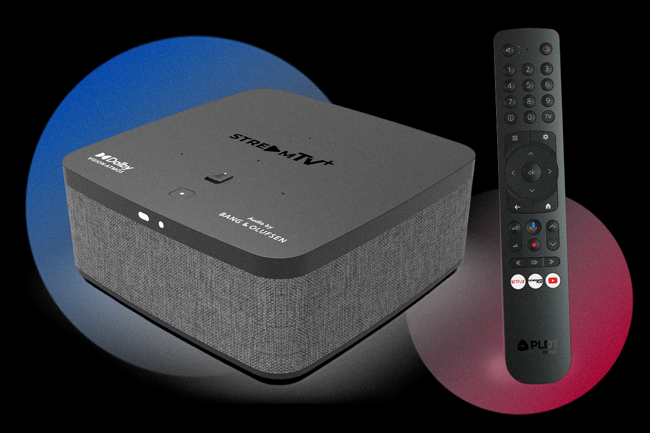 Streaming media box with fabric sides and 'StreamTV' branding, paired with a tall remote against a dark background with blue and red glow.