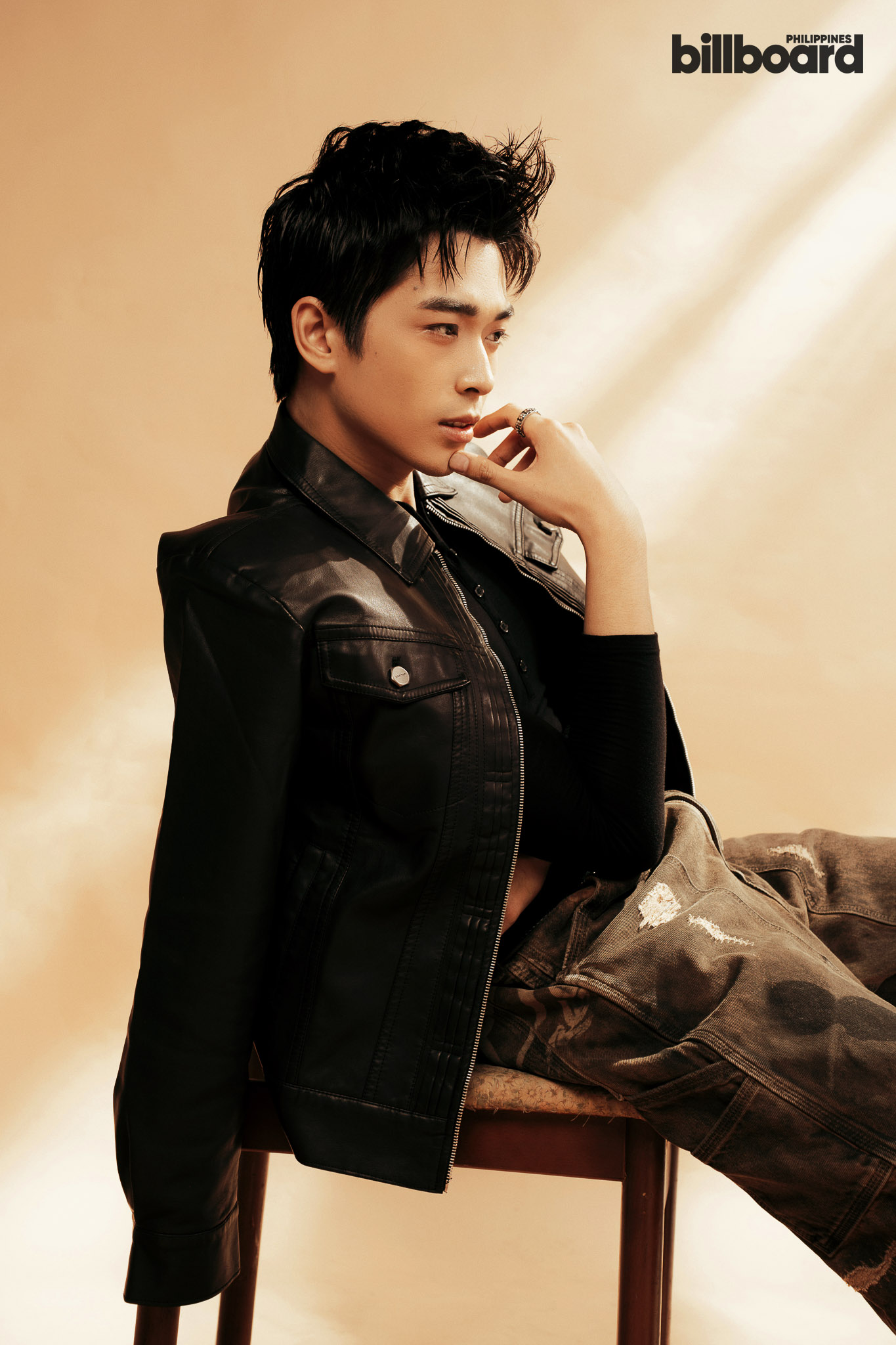 Portrait of a young man in a black leather jacket posing against a warm beige backdrop; Billboard Philippines logo in the top-right corner