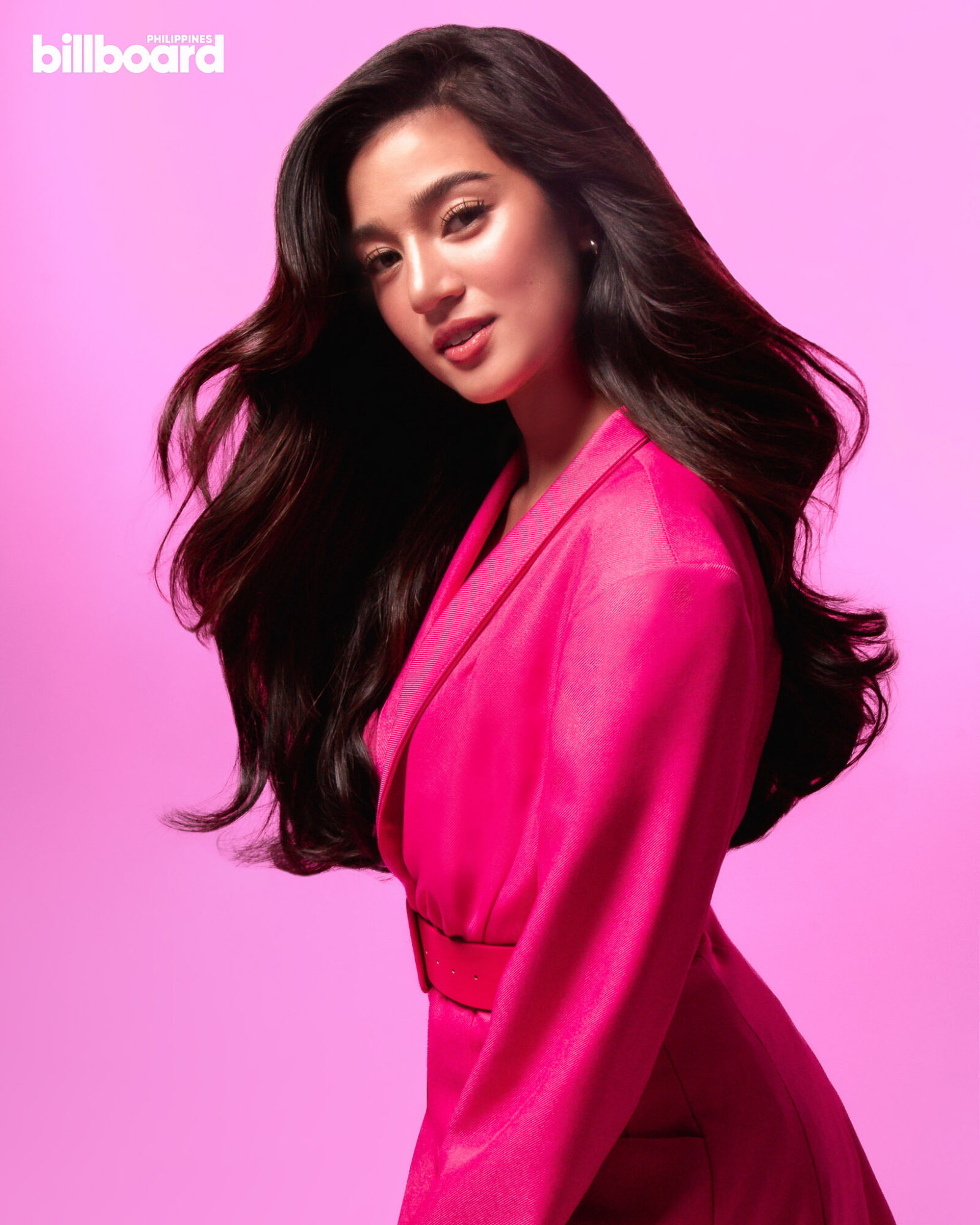 Belle Mariano dressed in magenta posing in front of a pink background